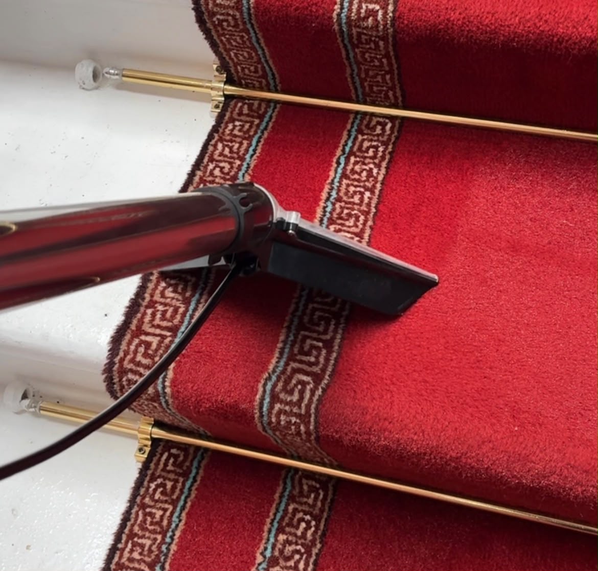 MERIT extraction wand working across a red carpeted stair
